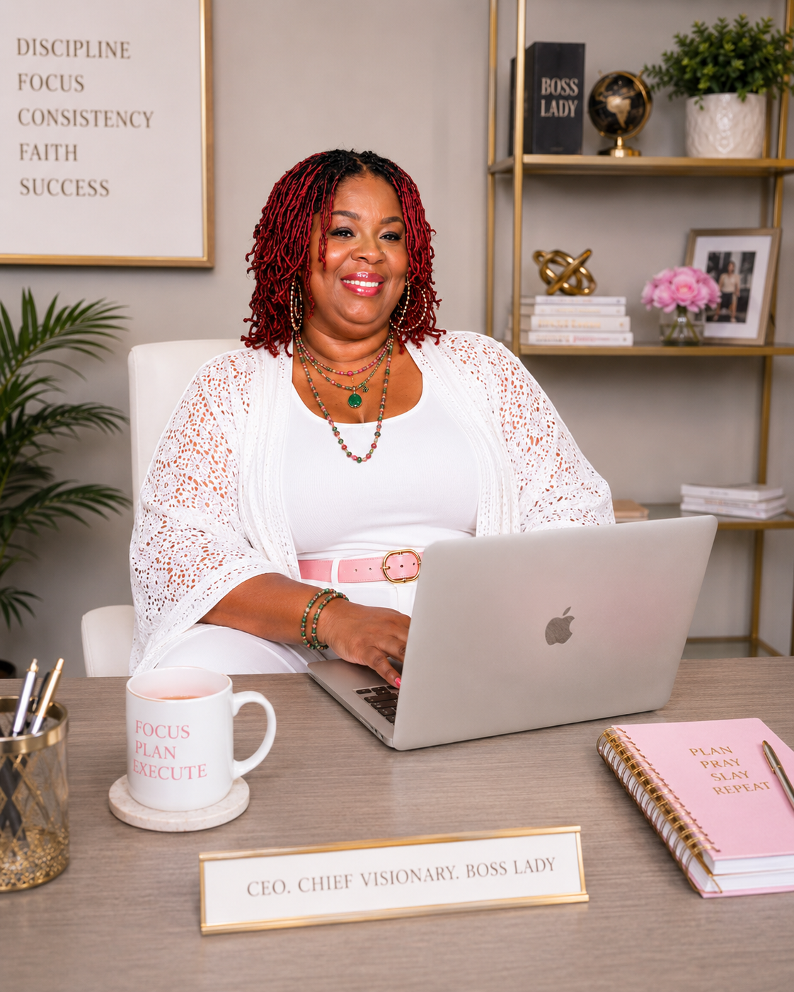 Kemi Miller seated at her desk with a laptop