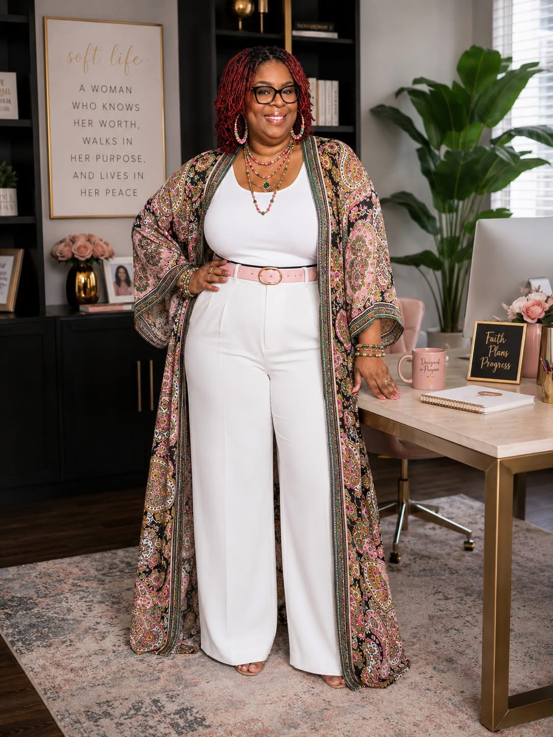 Kemi standing in her office in a white outfit and patterned kimono